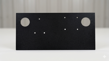 A black textured rectangular panel with two large circular cutouts and several small dot cutouts, displayed on a white surface against a light gray background.